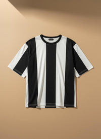 A short-sleeve crewneck t-shirt with bold vertical black and white stripes, displayed against a warm beige background.