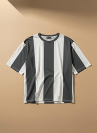 A short-sleeve crewneck t-shirt with vertical stripes in dark gray and white, displayed against a warm beige background.