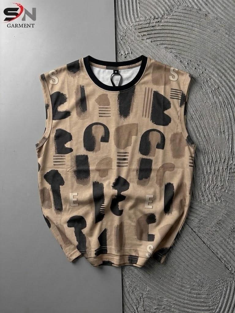Beige sleeveless shirt with black geometric pattern on a textured gray surface