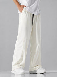 Premium men's cream white loose fit trousers featuring adjustable drawstring waistband, breathable fabric and modern wide leg design.