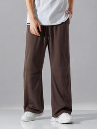 Stylish men's brown oversized trousers with a flowing wide leg design, elastic waistband and drawstring closure for all-day comfort.
