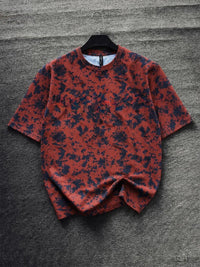 Men's rust red oversized graphic T-shirt with black abstract camouflage print, premium streetwear casual tee for everyday fashion by HUMRAAZ.