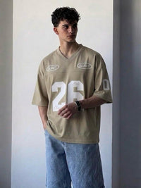Beige oversized men's V-neck jersey T-shirt with bold white 26 graphic print, premium streetwear oversized tee for casual and urban fashion by HUMRAAZ.